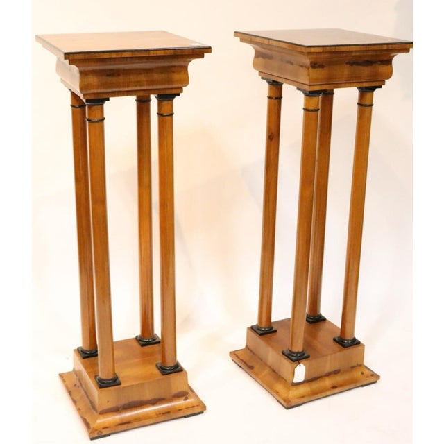 Pair of Tall Biedermeier style Pedestals Columns. Made of walnut wood and Bronze details The top base stands on 4 columns,...