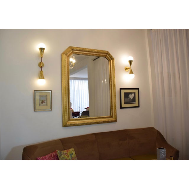 An impressive 20th-century octoganal shaped vintage Italian mirror. Its frame is meticulously sculpted from textured...