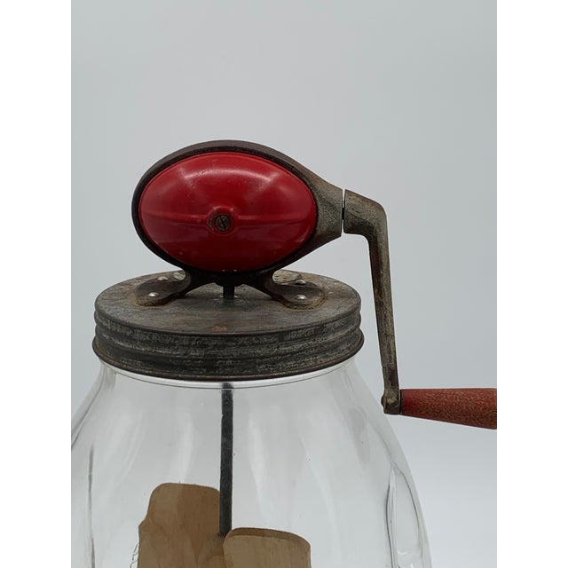 This vintage Dazey Paddle Butter Churn, circa: early 1900's, is a classic piece and features the iconic red bulb on top,...