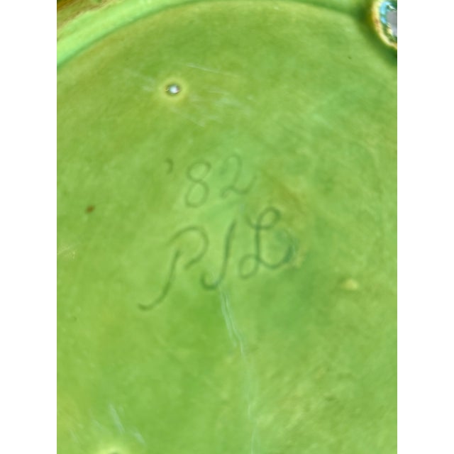 This beautiful vintage ceramic plate by Holland Mold, features a rich green glaze and an elegant scalloped rim. This piece...