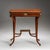 An elegant Viennese Empire side table in mahogany, crafted around 1810. The table features a single drawer and rests on...