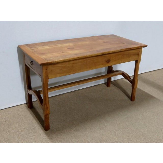 Rectangular table in solid light cherry wood, dating from the mid-nineteenth century. Its top is composed of 5 parts of...