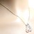 This Tiffany & Co. necklace by Elsa Peretti features a large rock crystal open heart pendant and is suspended from an 18k...