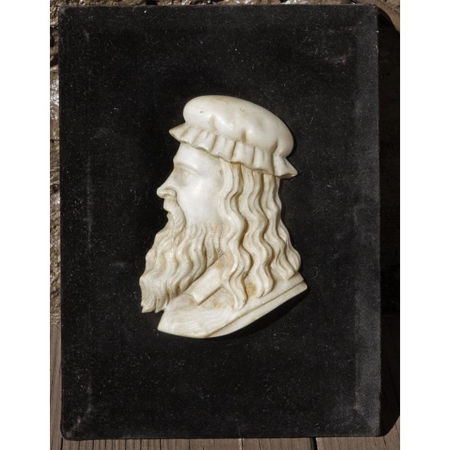 Carved profile bust of Leonardo Da Vinci. Mounted on velvet covered wood plaque. 19th century.