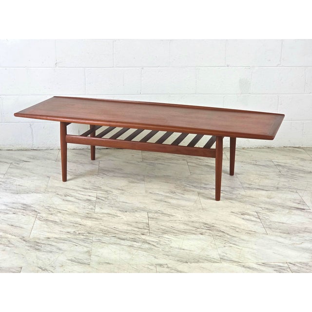 Iconic Danish Teak Surfboard Coffee Table By Grete Jalk For Glostrup Møbelfabrik. Features A High Lipped Profile Along The...