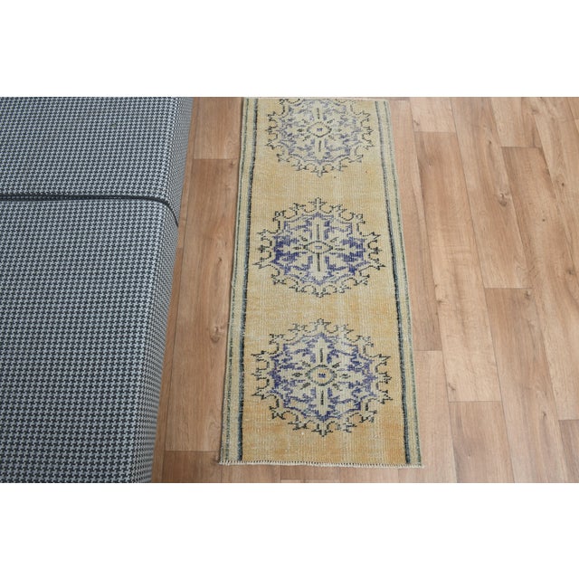 Vintage Hand-Knotted runner rug is a semi-antique vintage area rug. The '70s Eastern region of Anatolia's unique rug is...