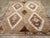 A Wool pile with symmetric knots on a wool foundation. The soft brown field, significantly abrashed, is notched at the...