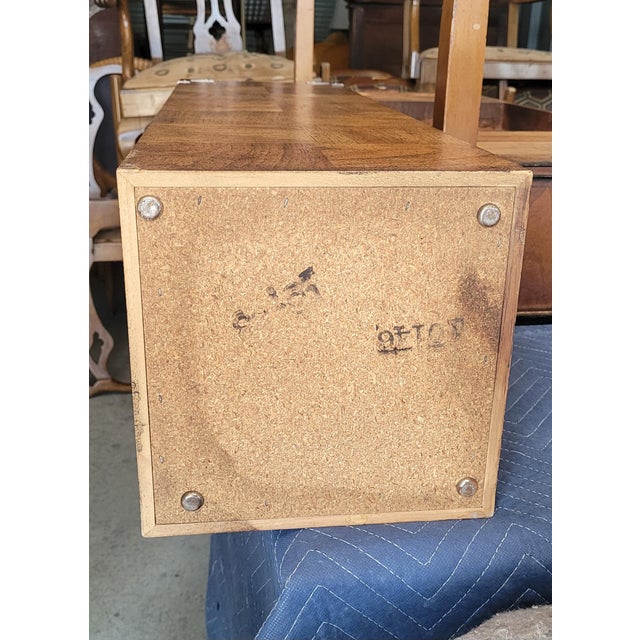 Vintage pedestals in the manner of Milo Bauman. Features a burlwood pattern body, black smoke glass tops and silvered...