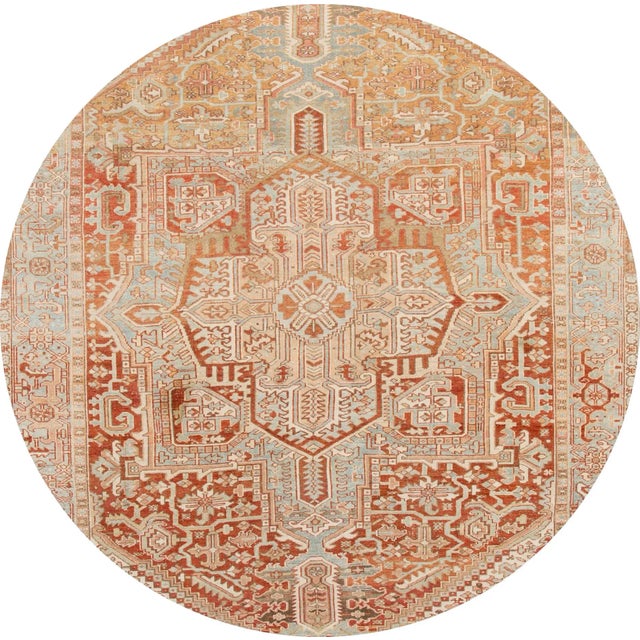 Beautiful Heriz hand-knotted wool rug with a peach field and gray frame. This rug has multi-color accents in all-over...