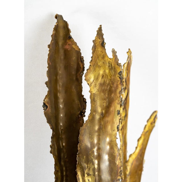 Extraordinary floor lamp, in the shape of Sansevieria, fashioned entirely in burnished brass and bronze, with wide and...