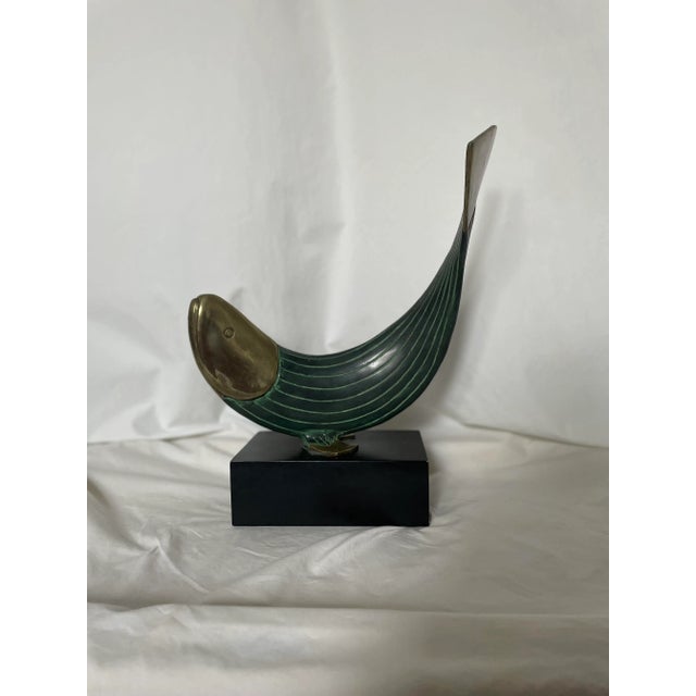 This modern metal fish statue by Dolbi Cashier is a stunning piece that is sure to catch the eye of any collector. Crafted...