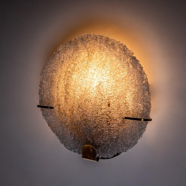Set of five disc-shaped wall lights featuring brass mounts and convex glass shades composed of interwoven, handcrafted...