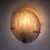 Set of five disc-shaped wall lights featuring brass mounts and convex glass shades composed of interwoven, handcrafted...