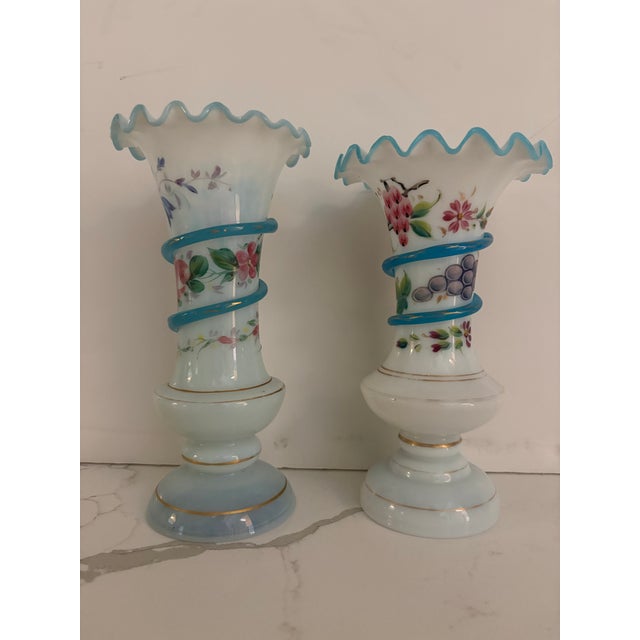 Gorgeous hand painting on these two Opaline art glass vases. I love the little blue glass snakes that twine around each...