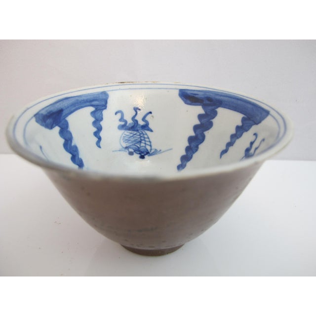 Chinese export Batavia Ware porcelain tea cup or bowl. Blue and white interior showing what I think are koi fish, and a...