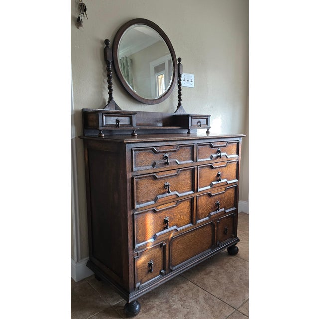 Antique Jacobean style dresser with mirror, circa early 1700s. Solid oak, geometrically paneled drawers. Front ball feet...