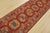 A tribal Caucasian Kazak runner hand-knotted with fine wool on a cotton foundation. This rug features a row of geometric...