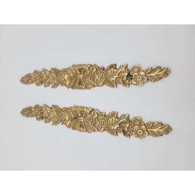 Add a touch of Neoclassical elegance to your home with this pair of solid brass decorative appliques from The Bombay...
