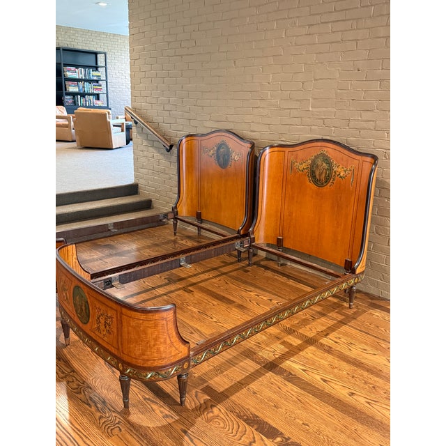 Beautiful antique satinwood and mahogany twin beds featuring handpainted details throughout. Each curved head/foot board...
