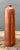 Vintage De Kuyper pottery bottle with a cylindrical form, warm reddish-brown finish, and a softly aged natural patina....