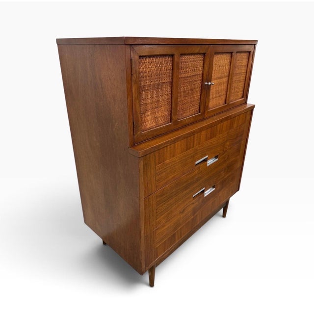 A handsome Mid-Century Modern American of Martinsville “Accord” walnut high chest, circa 1960s, showcasing the clean lines...