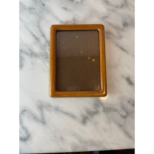 Mid 20th century solid teak wood picture frame designed in the Danish Modern style. Crafted from richly grained teak, this...