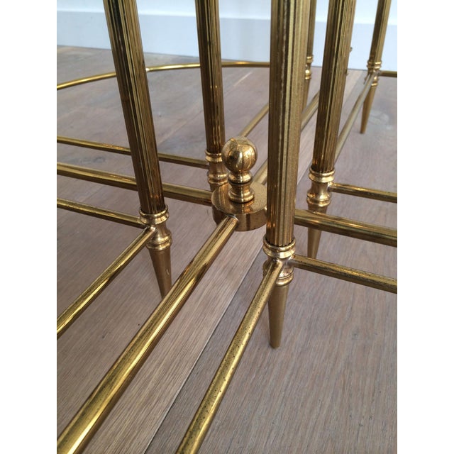 This very beautiful neoclassical round coffee table is made of brass with a round glass top. Four corner nesting tables...