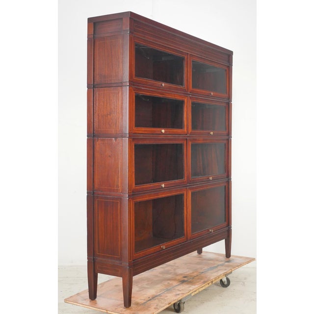 Early 20th century barrister bookcase with eight sections in four stacks, each with a lift and slide glass door. Deco...