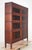 Early 20th century barrister bookcase with eight sections in four stacks, each with a lift and slide glass door. Deco...