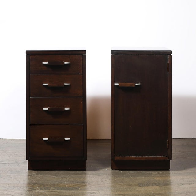This handsome Pair of Art Deco Eliel Saarinen for Johnson Walnut w/ Pulls & Smoked Glass Top tables/nightstands originated...