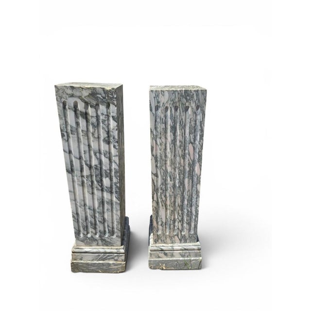 Elegant pair of marble pedestals carved in Italy during the 1920s. Crafted from fine Italian marble, these refined...