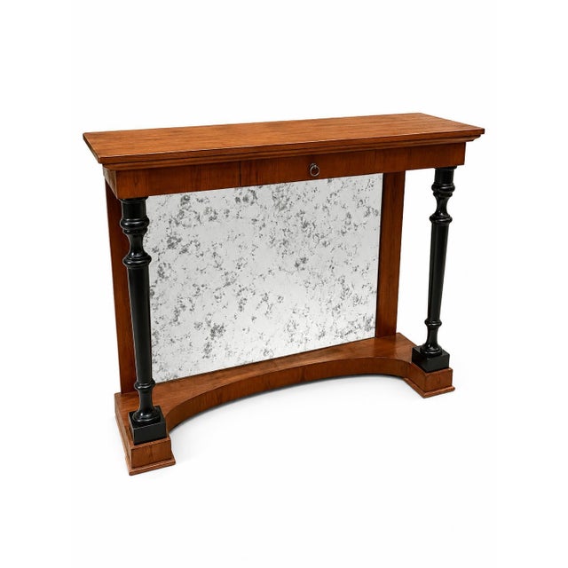 An elegant console table that combines Neoclassical and Biedermeier style elements, its harmonious proportions and...