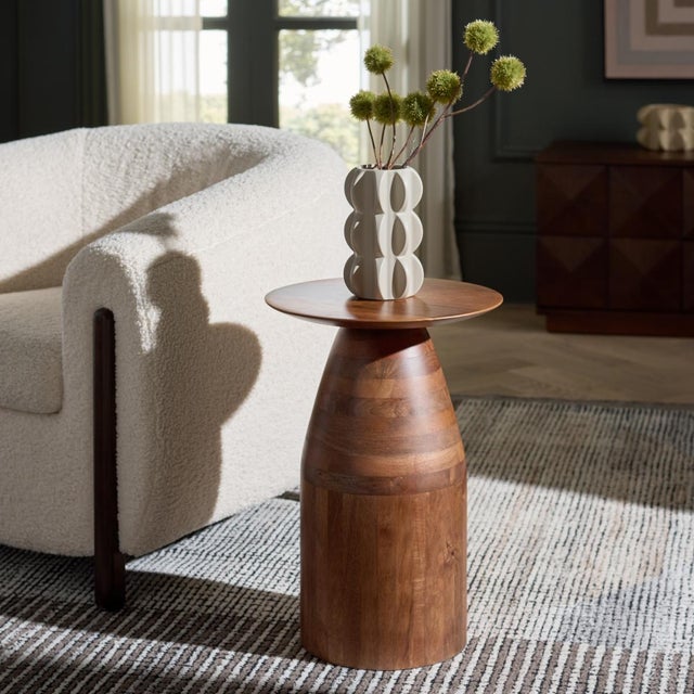 Transform your living space with the Karu Accent Table in elegant walnut. This beautifully designed piece seamlessly...