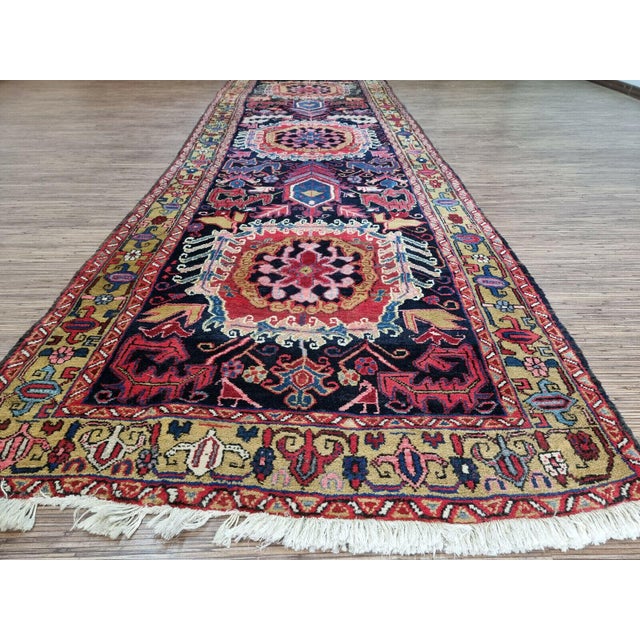 Handmade Antique Persian Style Heriz Runner Rug Add a touch of history and artistry to your home with this handmade...
