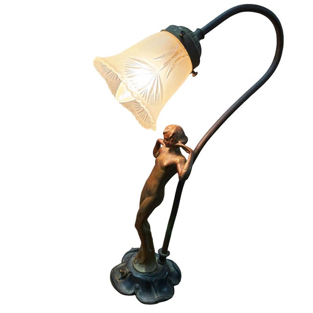 1920s bespoke Art Nouveau style figural table lamp features a beautifully cast patinated metal base depicting a stylized...