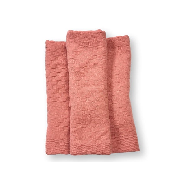 A beautiful set of eight antique French linen napkins in a rich light coral hue, hand dyed in small batches in Provence...