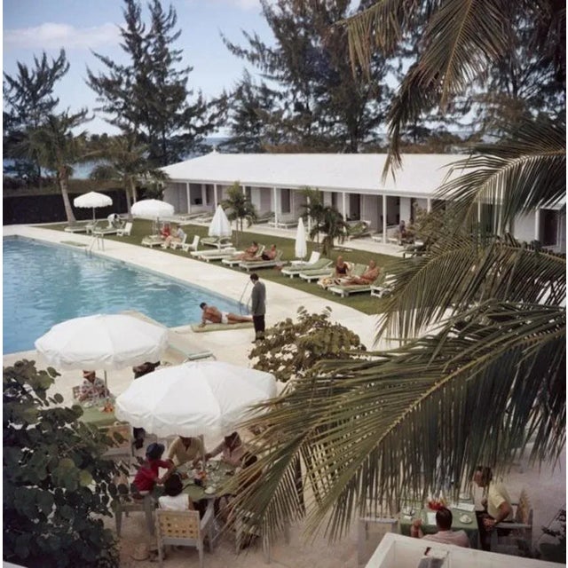 Poolside Service 1962 by Slim Aarons Slim Aarons Limited Estate Edition A swimming pool at the Lyford Cay Club at Lyford...