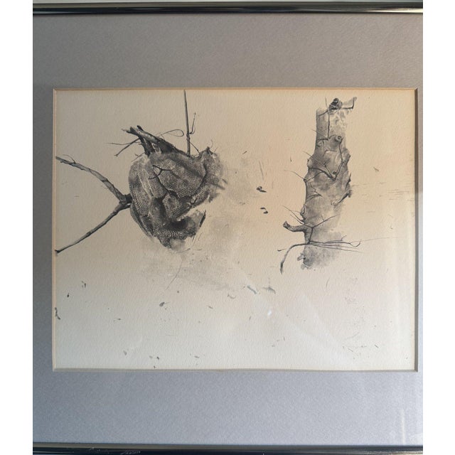 This is a framed reprint of Storing Up, a 1959 dry-brush work by Andrew Wyeth, one of the best-known American realist...