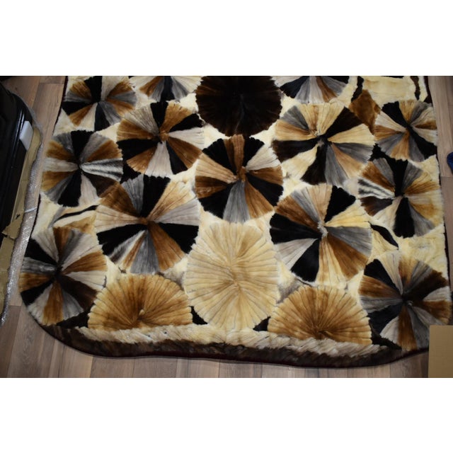 This is an amazing handmade mink quilt. It is queen size. It has red velvet trim and underside. The quilt is mainly a...