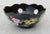 Chinese Enamel bowl, rolling rim design with a blue border and cascade of flowers descending from the rim. The bottom edge...