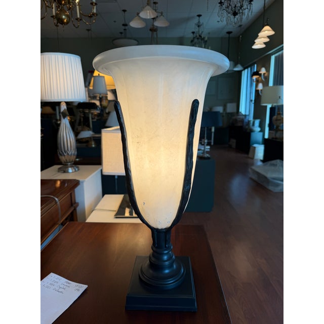 A vintage Haig table lamp featuring a carved alabaster urn with bronze accents supported by bronze accents and a...