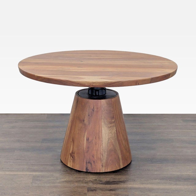 This ingenious round pedestal table has an industrial feel, revolving a solid acacia tabletop around a threaded center...