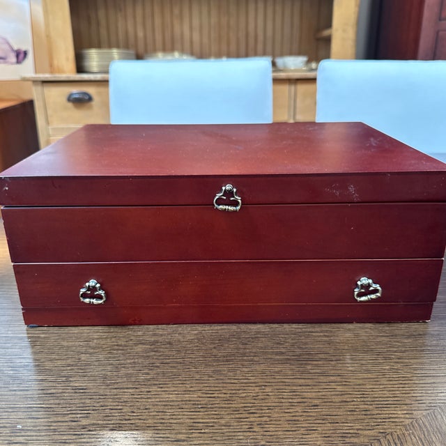 Design Plus Gallery presents a Flatware Box with Felt Lining. The box is in an auburn tone and resembles rosewood. It has...