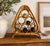 Add organic texture and sculptural charm to your space with this vintage rattan and bamboo wine holder. Featuring an eye-...
