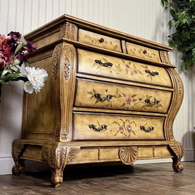 Hand-painted French Provincial–style bombe chest of drawers with a Venetian-inspired gold antiqued finish and carved...