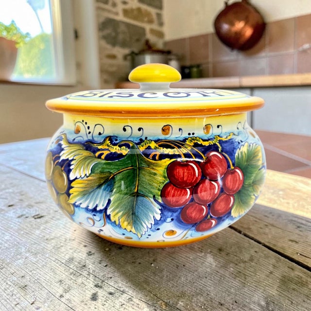 A large lidded biscotti or cookie jar by Gialletti Giulio of Deruta, Italy, hand painted in the traditional polychrome...