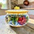 A large lidded biscotti or cookie jar by Gialletti Giulio of Deruta, Italy, hand painted in the traditional polychrome...