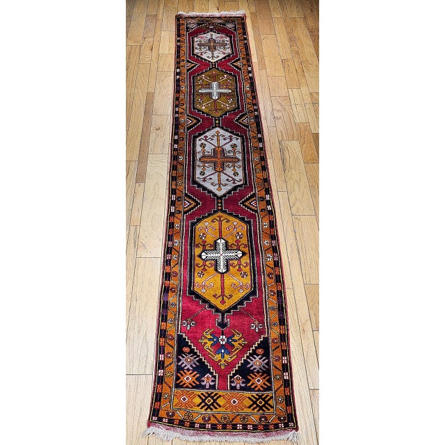 This vintage Turkish Oushak runner from the first half of the 20th century is a stunning example of Anatolian...