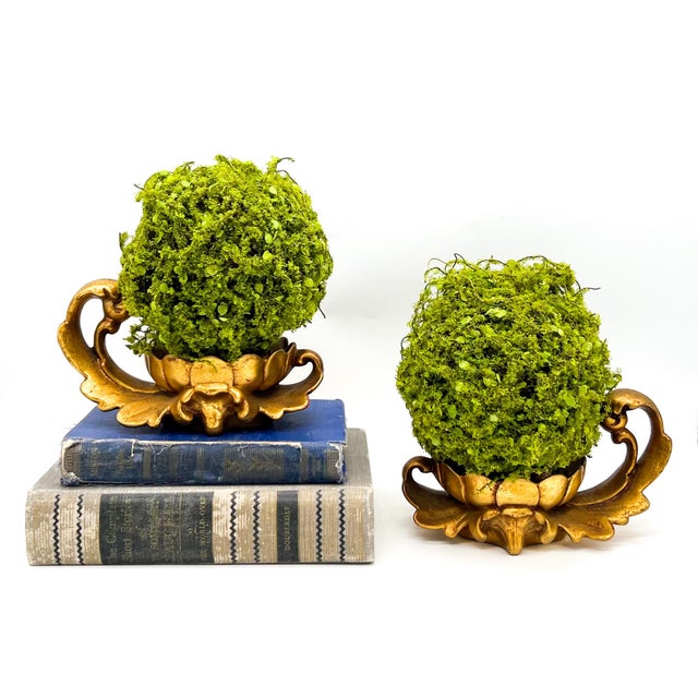 Stunning pair of lightweight gold gilt ceramic pedestals featuring ornate Rococo-style scroll handles and decorative...