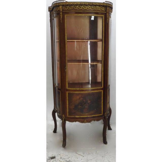 We are offering a beautifully detailed French Vitrine with outstanding Ormolu features. The top is finished with grey and...